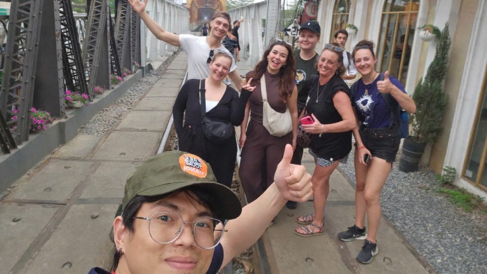 Guests Kevin and Fiona from Austria and Spain exploring Long Bien Bridge during a Hanoi free walking tour in the Old Quarter with local guide Zwi