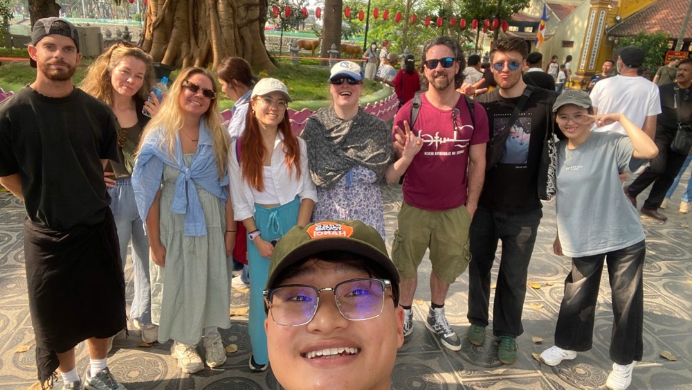 International guests with local guide Mint during a Hanoi City Highlights walking tour exploring Hanoi’s cultural landmarks.