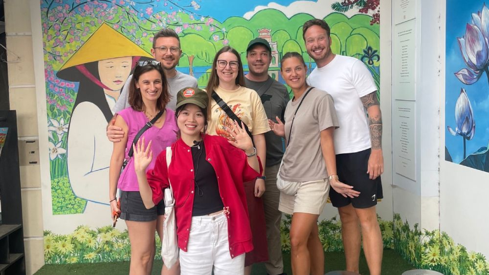 International travelers enjoying a Hanoi Old Quarter free walking tour with a local guide