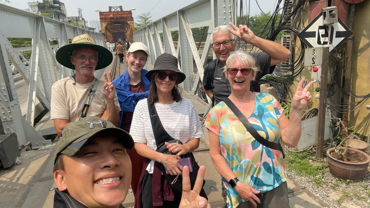 Guests Mariane, Paul and Catharina enjoying Long Bien Bridge during a Hanoi free walking tour with local guide Chris