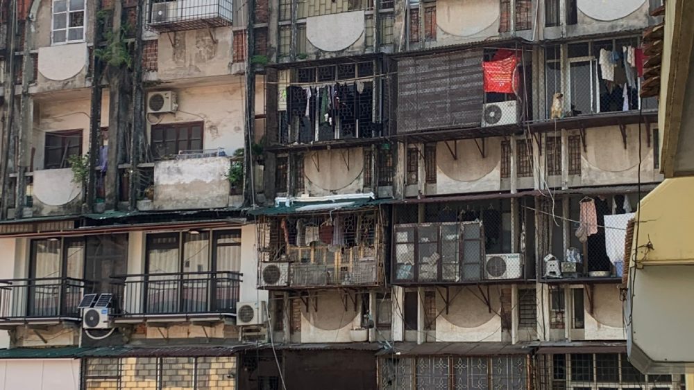 Old residential apartment buildings in Hanoi Old Quarter visited during a free walking tour