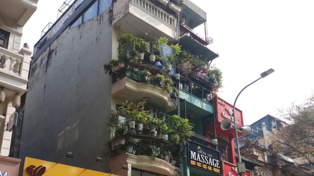 Traditional buildings and local street life in Hanoi Old Quarter during a Hanoi walking tour