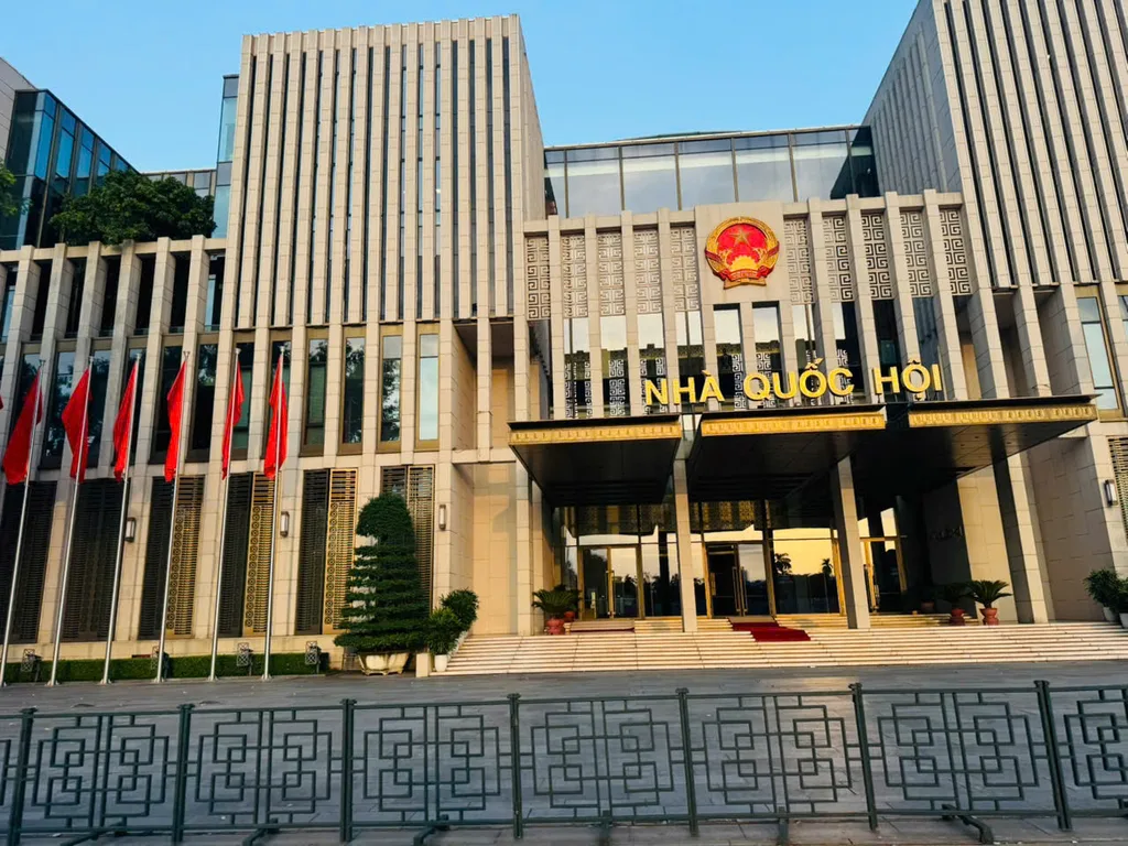 National Assembly House facade with flags and plaza in Hanoi.