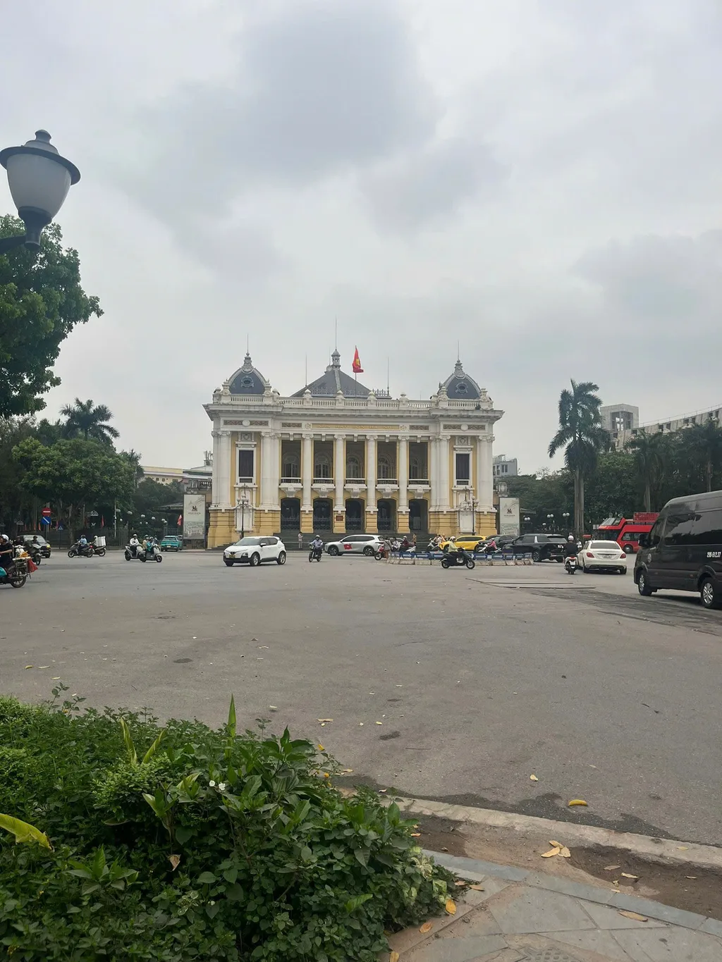 Neoclassical Hanoi Opera House with yellow facade and domed roof from the square.