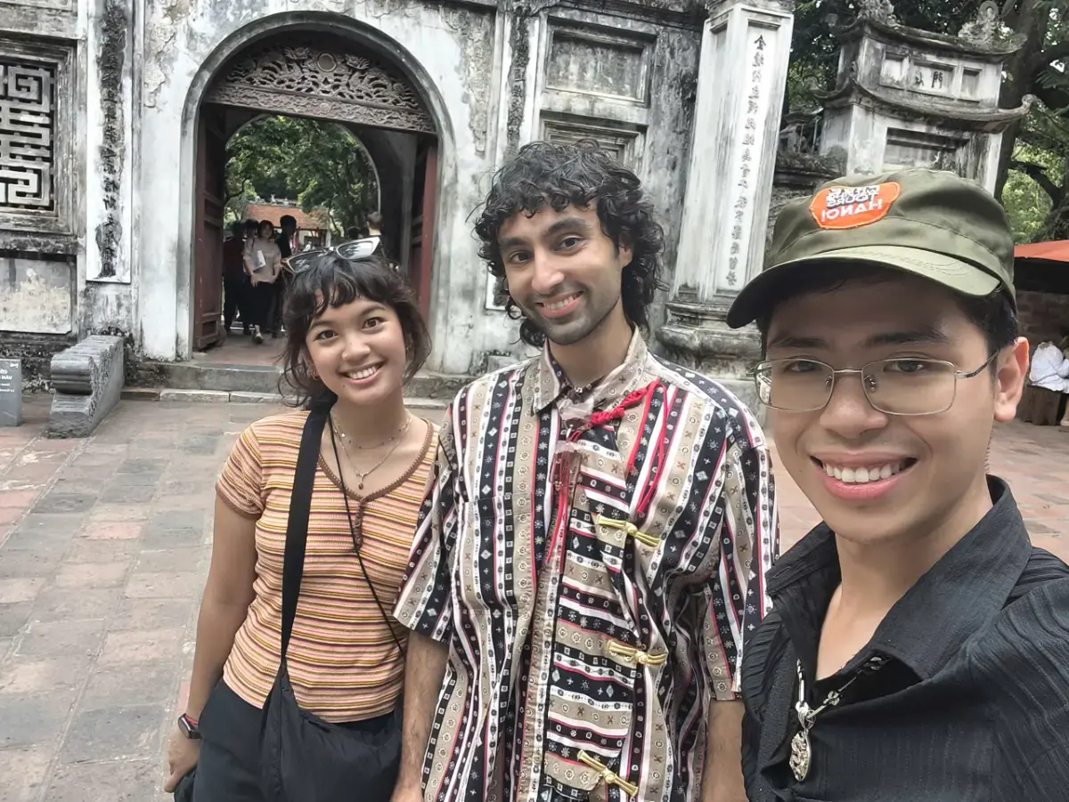 British traveller Efrata with local guide William at the Temple of Literature (Van Mieu) gate during a Hanoi cultural walking tour.
