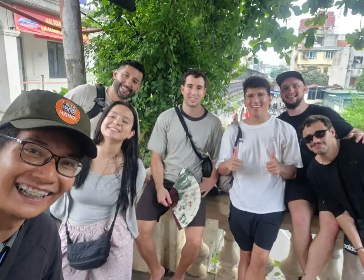Spanish traveller Rubén and guide Julio near O Quan Chuong Gate and Long Bien Bridge during a Hanoi walking tour.