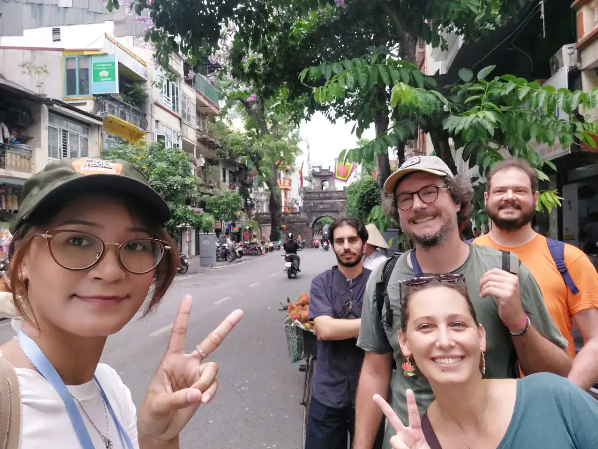 Guide Hannah and guest James Burgesw exploring Phung Hung Mural Street, Dong Xuan Market and Ta Hien Street in Hanoi Old Quarter.