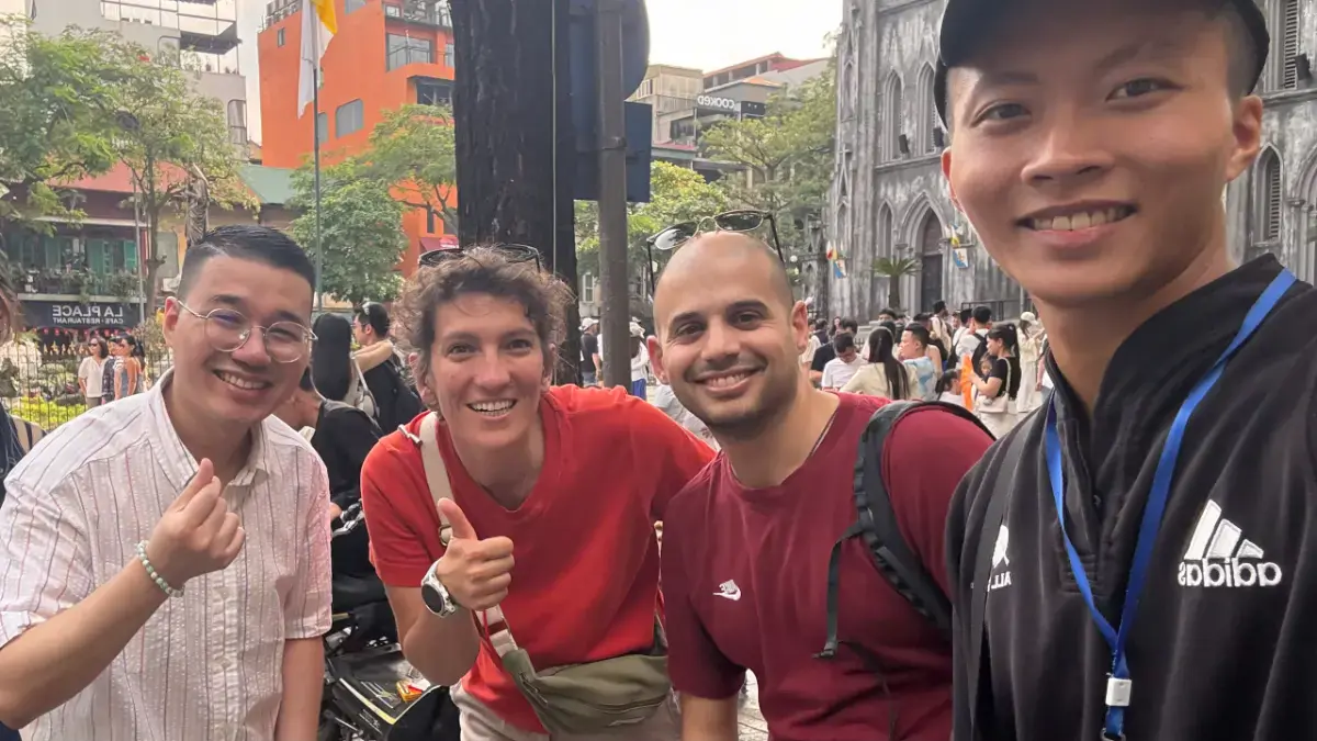 Guide Tommy and guest Garima Nigam exploring Thanh Ha Market and Long Bien Bridge during a Hanoi Old Quarter walking tour.